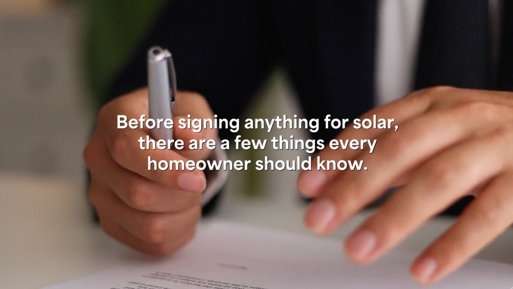 Hands holding a pen over a document with text overlay: "Before signing anything for solar, there are a few things every homeowner should know.".