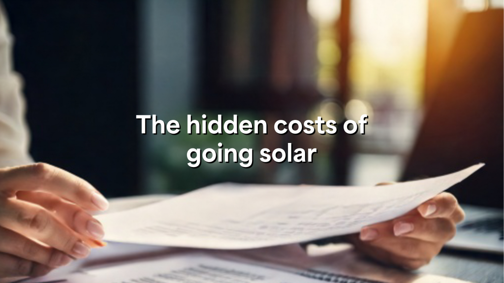 Hands holding a document with text "The hidden costs of going solar" overlaid on a blurred background.